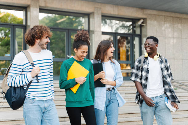 istock Group of University Students Walking after classes Holding Books And Laughing 1467685284
