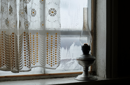 old gas lamp on a window sill, lantern, close-up