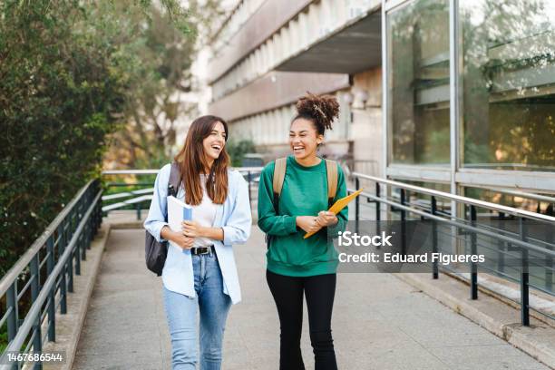 University Student Girl Friends With Learning Books Walking Out School Building Stock Photo - Download Image Now