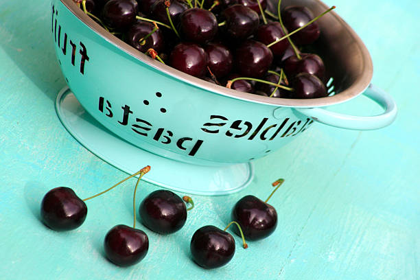 cherries in a kitchen strainer