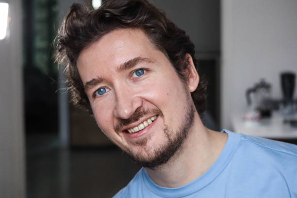 istock Handsome young man with blue eyes and wavy hair smiling 1467688557
