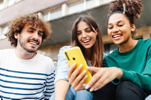 istock University student friends using mobile phone together to share content on social media 1467688767