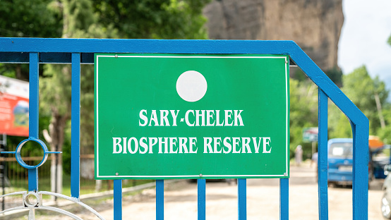 Signage for Sary-Chelek Nature Reserve landscape, a protected area located in Kyrgyzstan. It is home to a diverse range of plant and animal species