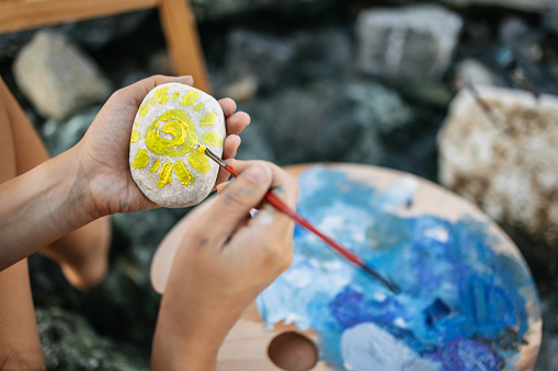 Summer is almost here! Painting a sun on a rock