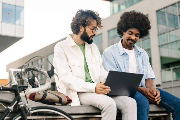 istock Modern friends working on laptop next to bicycle - Young entrepreneurs creating healthy business model 1467690663