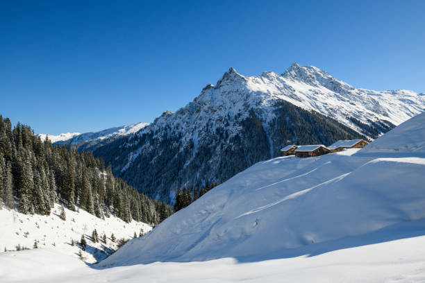 Winter landscape with snowcapped old huts in the mountains of the ski-resort Gargellen
