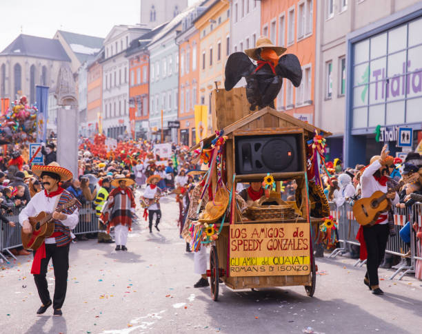 The participants of the traditional festival parade in Austria wear colorful and masquerade clothing as they move through the streets of Villach during the annual event Fasching Villach, Austria - 2023 February 19: Carnival in Villach, Fasching, Participants in the annual parade wear colorful and masquerade clothing. Motto: Lei-Lei. villach stock pictures, royalty-free photos & images