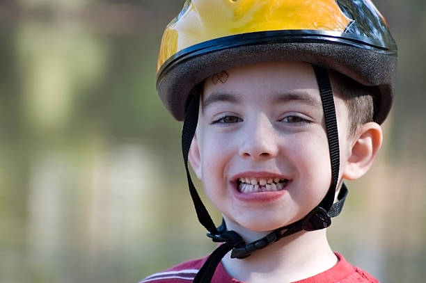 istock Young Boy with bike helmet and missing tooth 146769595
