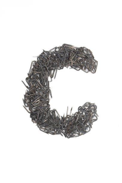 istock artistic lowercase Letter c made from steel staples isolated on a white background write, font, type style 1467696003