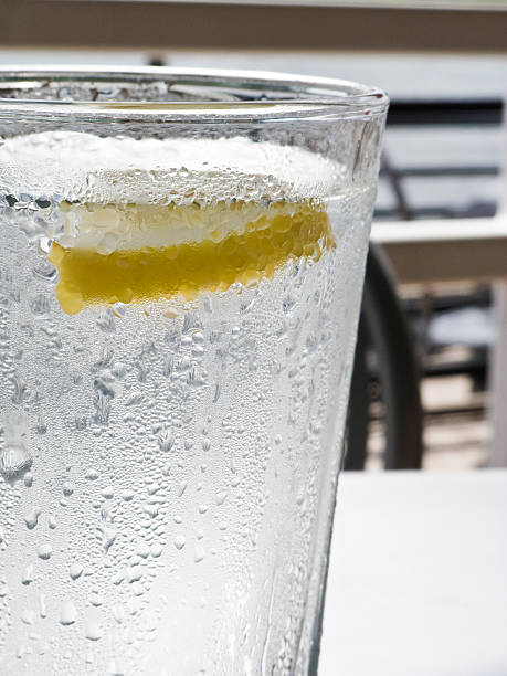 Glass of water with lemon stock photo