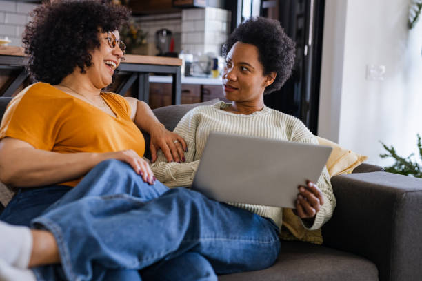 istock Lesbian couple relaxing on a sofa at home 1467701540