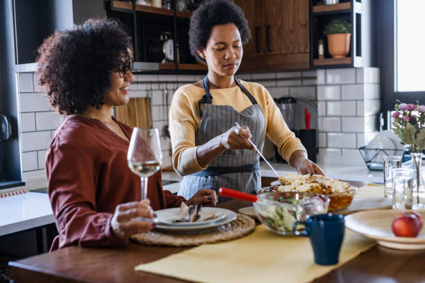 istock Two mature woman having a dinner at home 1467701547