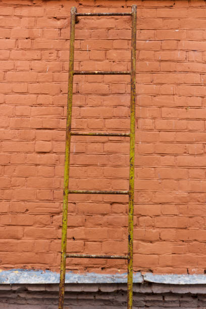 istock A yellow ladder on the background brick wall. 1467703164