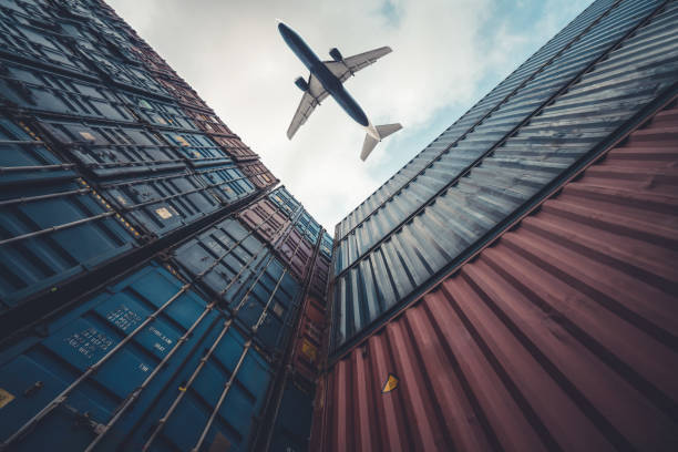 istock Freight airplane flying above overseas shipping container . Logistics supply chain management and international goods export concept . 1467703524