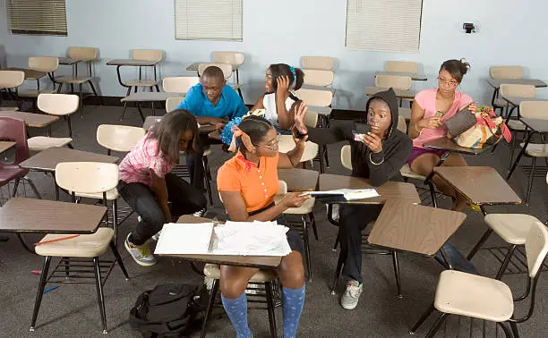 Photo of Highschool students messing in class during break