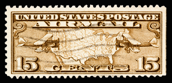 A 1926 issued 15 cent United States Airmail postage stamp showing two planes and map of America.