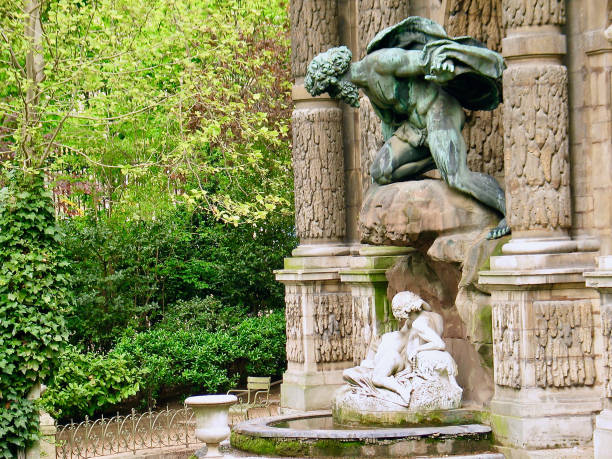 A statue of a woman reading in Autumn at the Boboli Gardens in Florence Italy