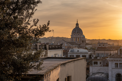 Enjoying the wonderful colors of sunset on the roofs of Rome in Italy