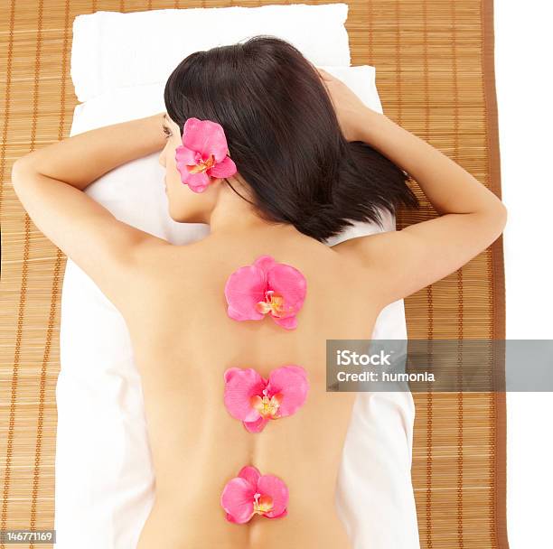 Attractive Woman Relaxing Spa With Flowers Stock Photo - Download Image Now - Adult, Adults Only, Alternative Therapy