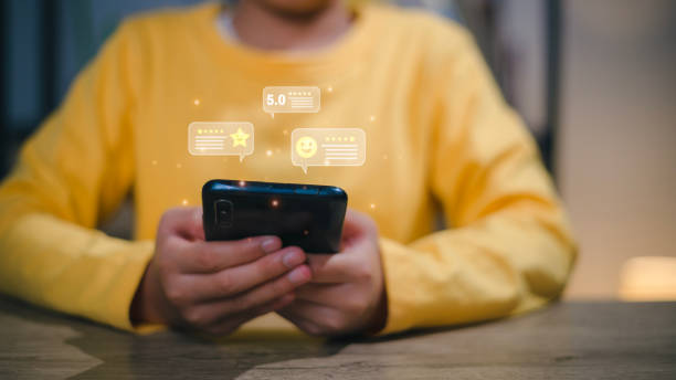 istock Woman pressing face emoticon on the virtual touch screen at smartphone. Customer service evaluation concept.reviews, feedback, survey 1467713857
