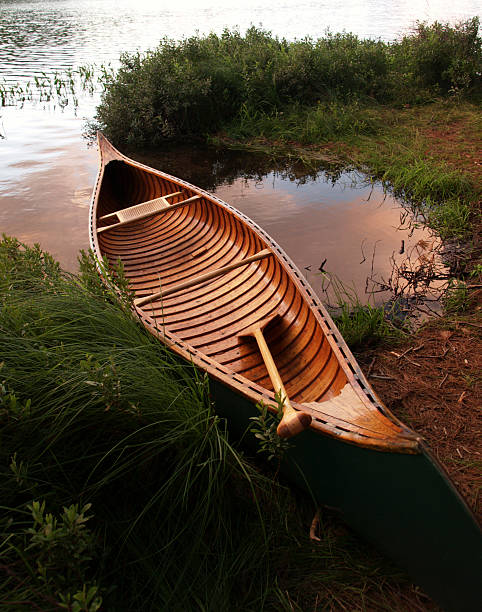 wooden canoe on Adirondack lakeshore stock photo