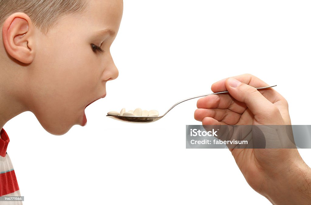 child taking medicine child taking medicine on white background Addiction Stock Photo