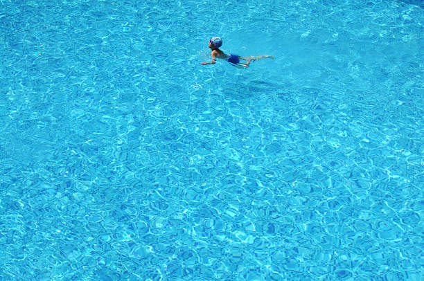 istock The little boy swims in blue water 146771593
