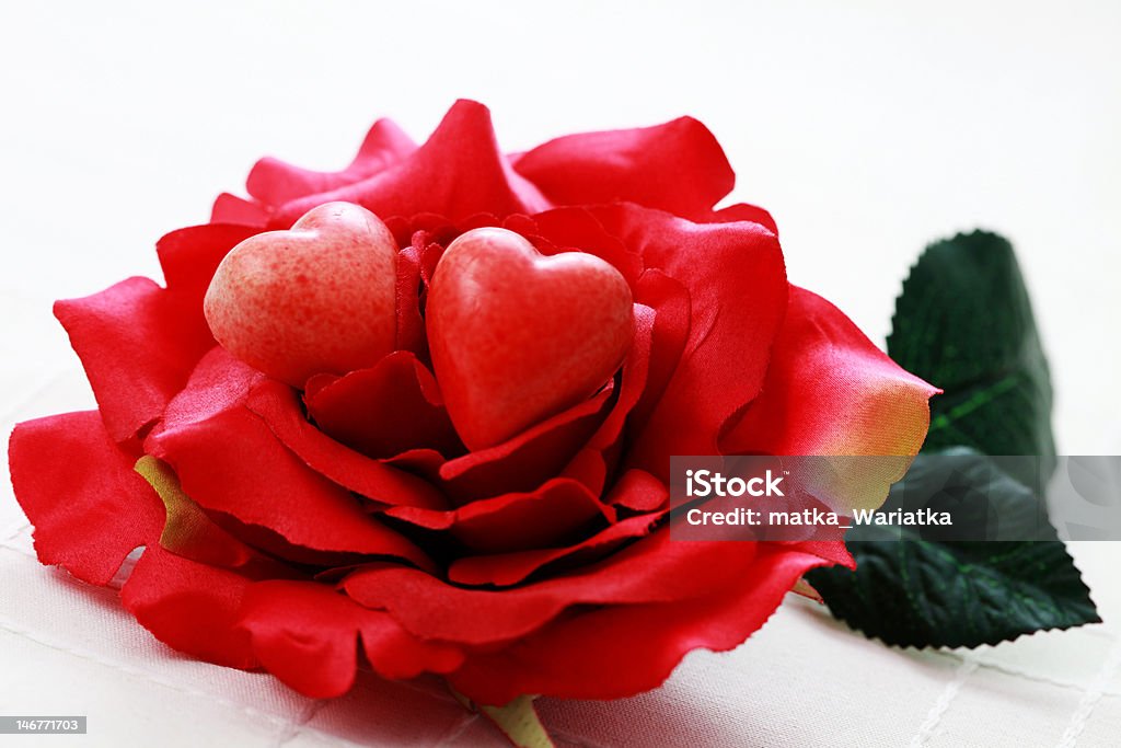 red pralines red hearts pralines on rose - sweet food Birthday Stock Photo