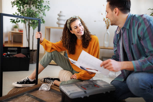 istock Young beautiful couple assembling furniture while reading instruction manual in their new apartment 1467717335