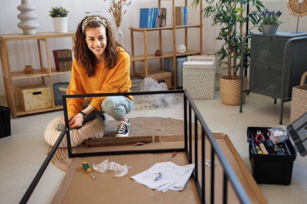 istock Young beautiful woman assembling shelf in her new apartment 1467717412