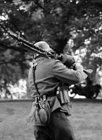 Gomel, Belarus - November 26, 2016: Reconstructor German Wehrmacht soldier with an automatic rifle of the Soviet production on the back. Black and white snapshot