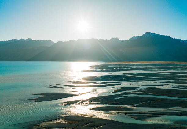 Beautiful turquoise Lake Pukaki and snow capped Mount Cook Glacier Mountain Range in summer reflecting in the turquoise calm lake water. South Island, Canterbury, Mackenzie Basin, Mount Cook, Lake Pukaki, New Zealand