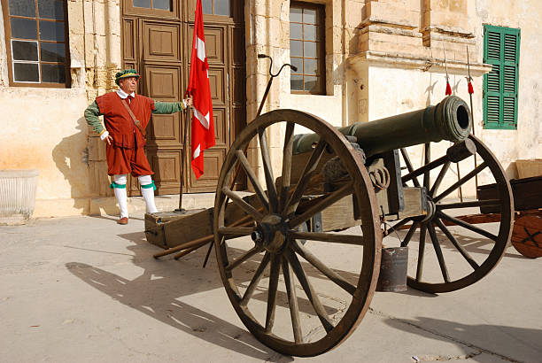 old-fashioned cannon and guard in costume, Fort St. Elmo, Malta