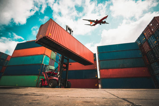 istock Cargo container for overseas shipping in shipyard with airplane in the sky . Logistics supply chain management and international goods export concept . 1467722944