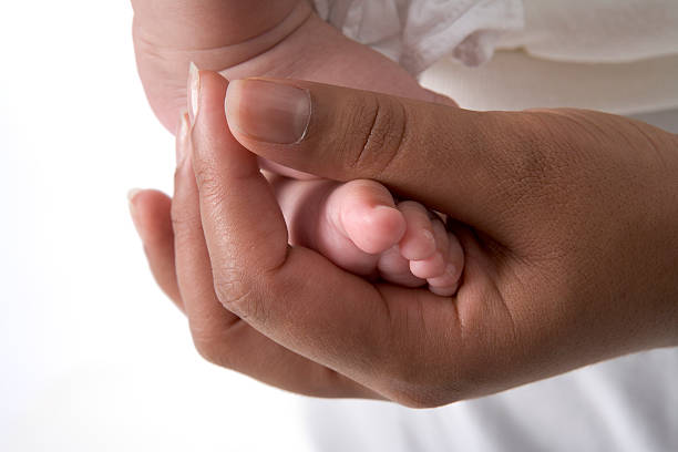 istock Mother hand with babyfoot 146772414