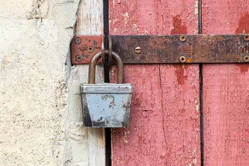 Old lock on the door.Rusty lock on the door of an old farmhouse . True village style .Focus on lock.