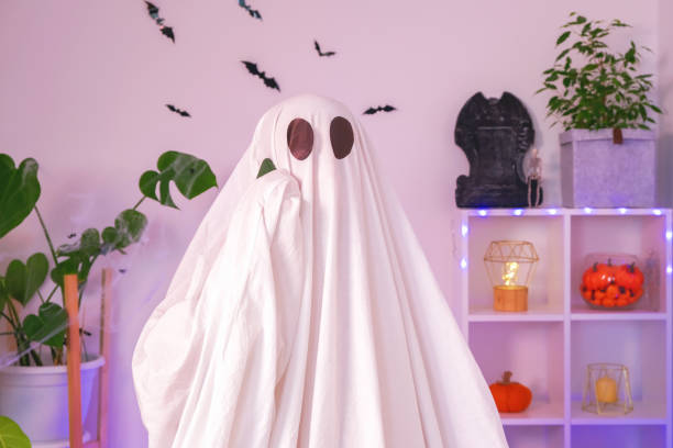 istock The Halloween Ghost uses a mobile phone for calls, congratulations, intimidation. The ghost makes an order from smartphone on Halloween. Funny Halloween concept. 1467731534