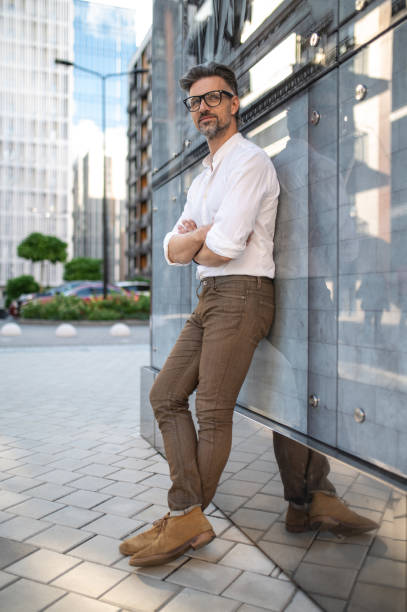 istock Good-looking mature man in eyeglasses and white shirt 1467732378