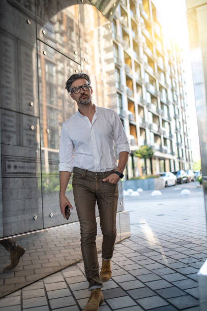 istock A tall good-looking man walking in the office area 1467732404