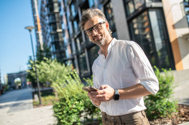 istock Man with a phone in hands standing at the road 1467732452