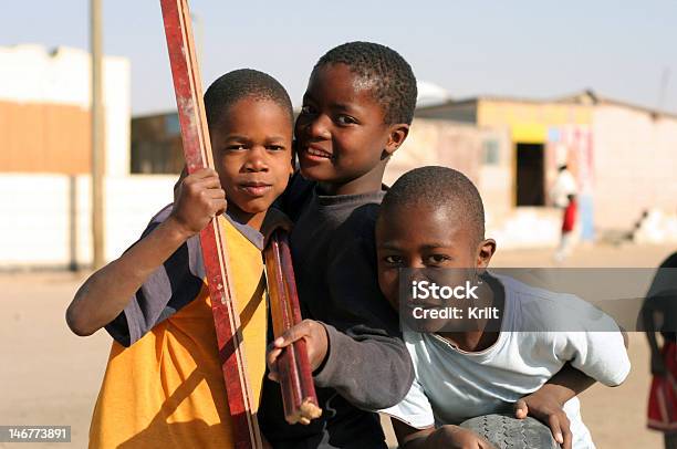 Three Young African Boys Gathered In Street Stock Photo - Download Image Now - Namibia, Child, Teenager