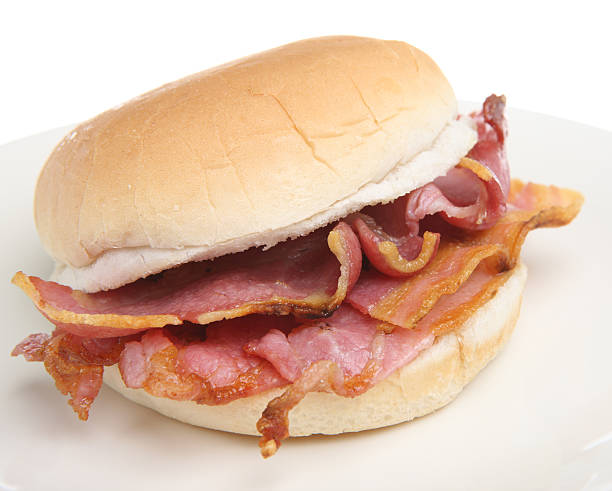 istock Close-up of a bacon breakfast sandwich on a bun on white 146773927