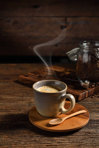 cup of coffee with smoke and coffee beans on old wooden background - bag coffee bean bean food imagens e fotografias de stock