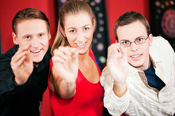 istock Group of friends playing darts 146774152