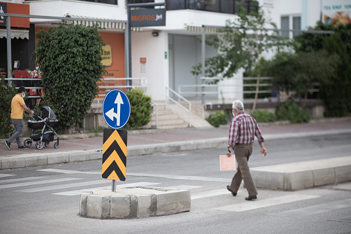 A street view in Konyaaltı/Antalya/Turkey. We see a person crossing the pedestrian crossing. Date: 06/19/2020
