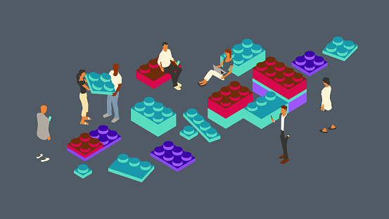 Seven people gather to assemble a set of software or design components, such as those found in a design system, and represented by a set of oversized interlocking blocks. A technology theme is emphasized by the flat color palette, including bold purple, turquoise, and magenta highlights on a dark gray background. Conceptual illustration is presented in isometric view on a 16x9 artboard, using vector shapes throughout.