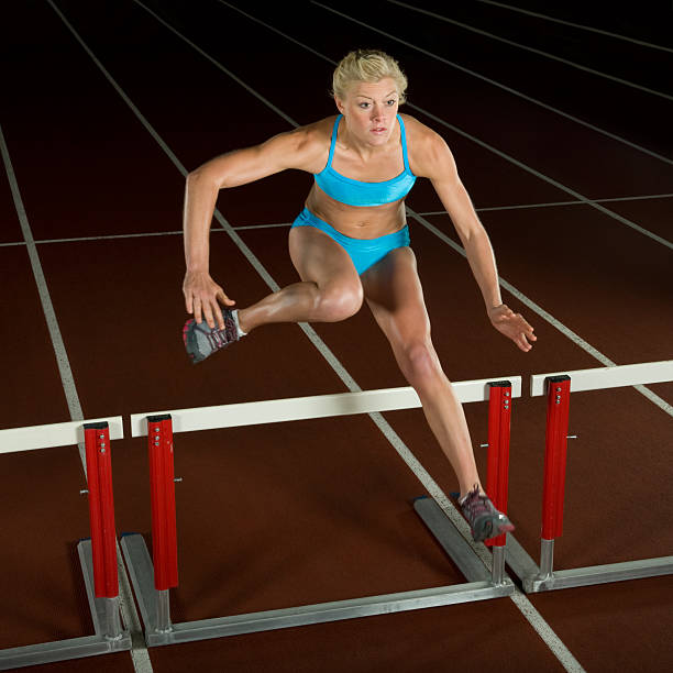 istock Woman Jumping Over Hurdle 146774634