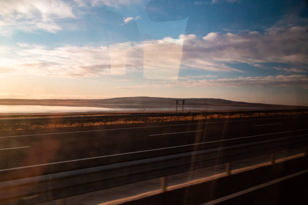 highway and salt lake from car window. Sunset landscape. cloudy sky. Ankara Turkey.