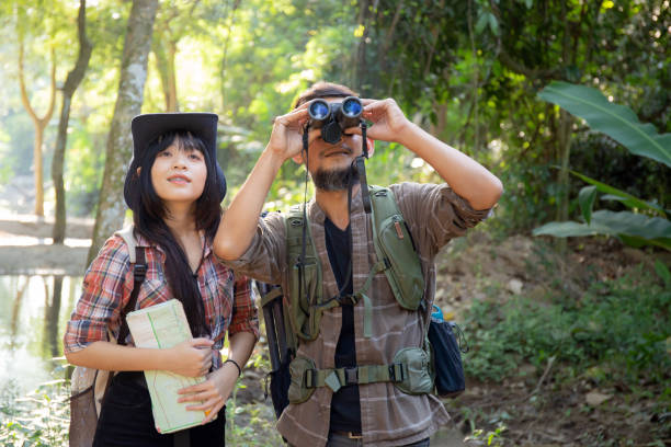 istock Family with father and daughter tourist backpack hiking doing activity while father looking binoculars in holiday together, man and teenager woman journey adventure trip and looking map. 1467748073
