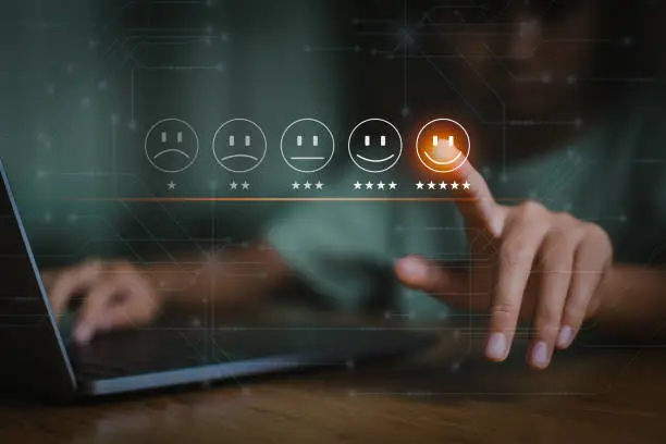Photo of Young woman is touching the virtual screen on the happy Smiley face icon to give satisfaction in service. Best excellent services rating. Customer service and Satisfaction concept.